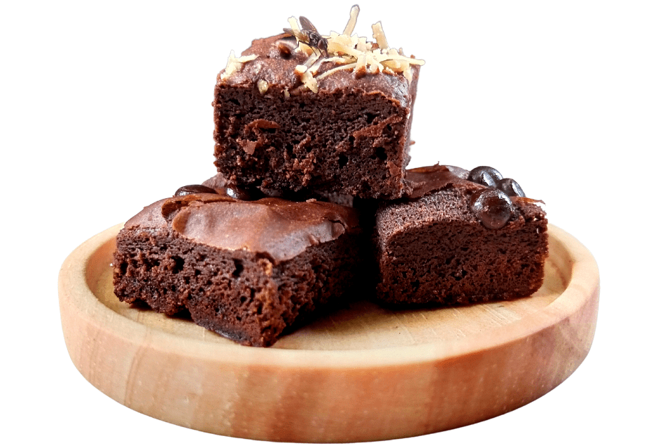 Rich chocolate brownies with chocolate chips and a soft fudgy center stacked on a wooden serving plate.