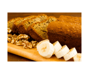 Freshly baked banana walnut bread with sliced bananas and walnuts displayed on a wooden serving board.