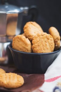 Freshly baked peanut butter cookies served in a bowl with a warm golden-brown finish.