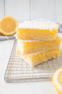 Lemon bars with a buttery crust, bright lemon filling and powdered sugar for dessert catering in Charleston, SC.