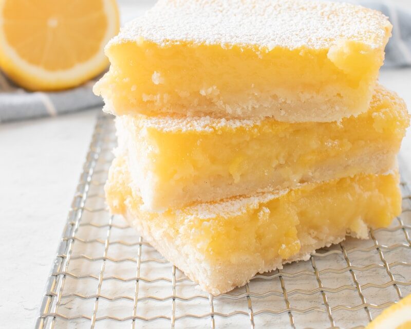 Lemon bars with a buttery crust, bright lemon filling and powdered sugar for dessert catering in Charleston, SC.
