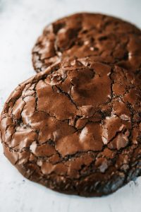 Large fudgy double chocolate brownie cookies with crisp crackled tops and rich, chewy centers, freshly baked and ready to serve.