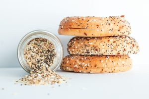 Fresh everything bagels topped with sesame seeds, poppy seeds, garlic, onion, and seasoning blend, showcasing the premium artisan breads used by Bites of Charleston in Charleston, SC.