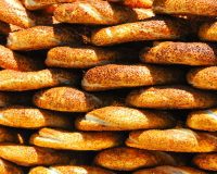 Stack of freshly baked sesame seed bagels with golden crusts, prepared for breakfast catering and brunch events by Bites of Charleston in Charleston, SC.