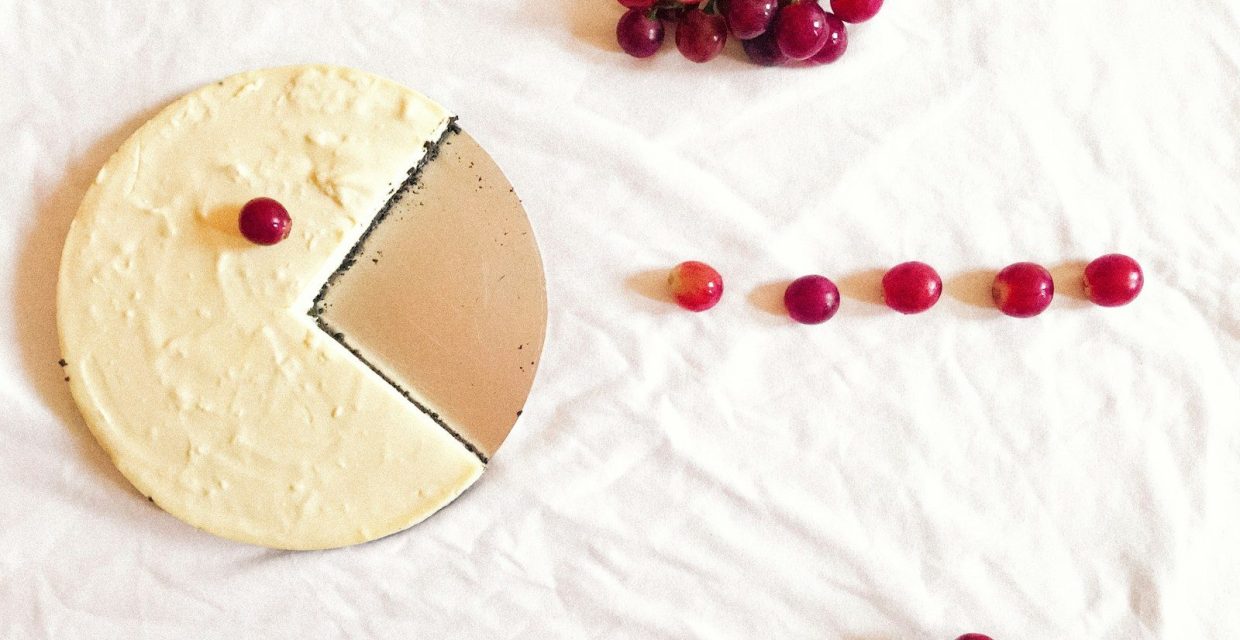 Elegant gourmet cheesecake with fresh red grapes displayed for Charleston dessert catering and special events.